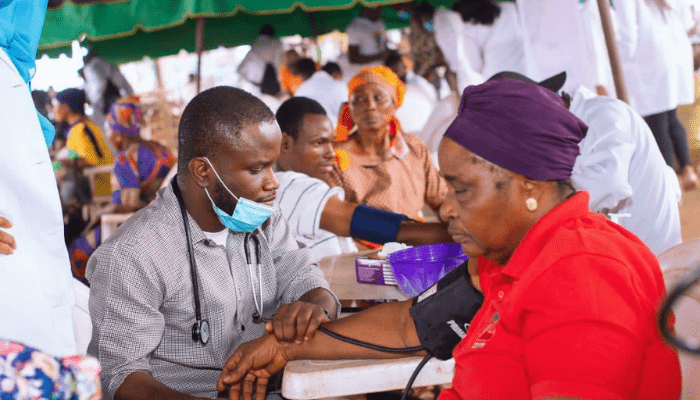 Dr. Olalekan Israel Efunkunle checking blood pressure of patient during the Taiwo Afolabi Free Rural Dental Outreach in Ibadan, organized by UADS and CODEH